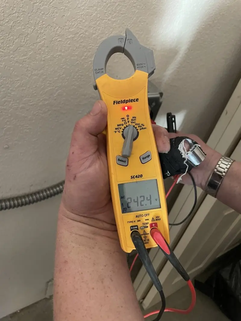Voltage testing with clamp meter during Electrical Installation Services in Lake Grove